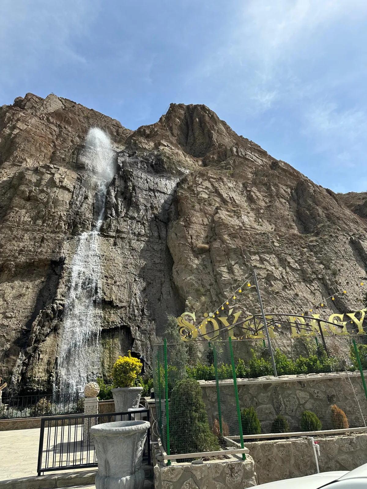 A high waterfall on a rocky mountain in the well-maintained Söýgi Dagy resort area in Turkmenistan