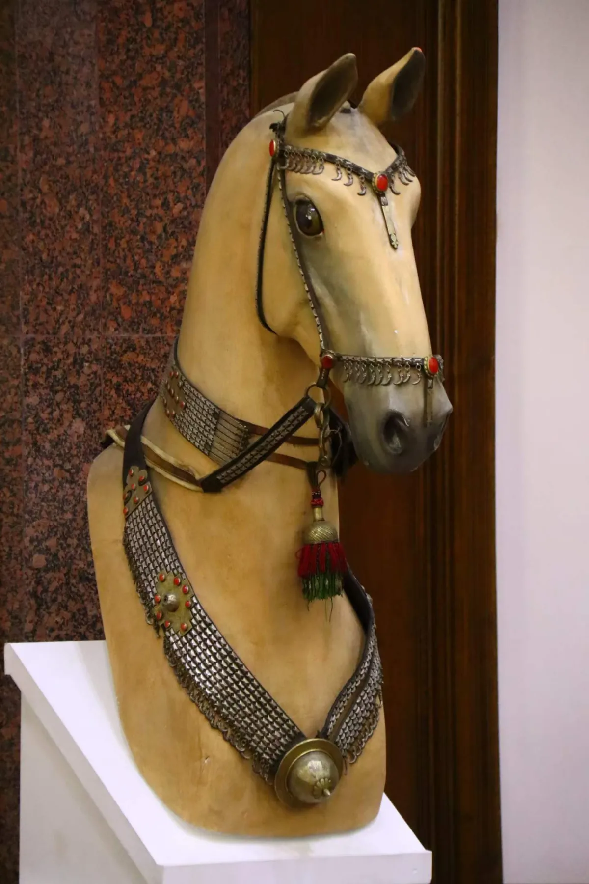 Bust of an Akhal-Teke horse in traditional Turkmen silver harness with red stones