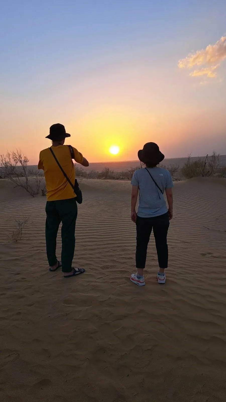 Tourists on the dunes watching the sunset in the Karakum Desert in Turkmenistan