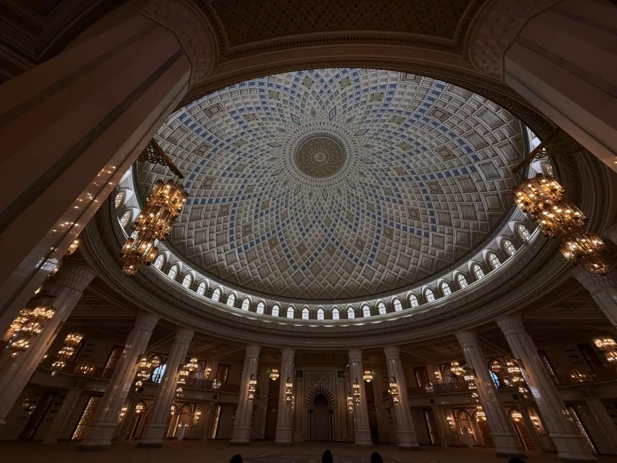 Luxurious inner dome of the Turkmenbashi Ruhy Mosque with golden chandeliers and traditional patterns